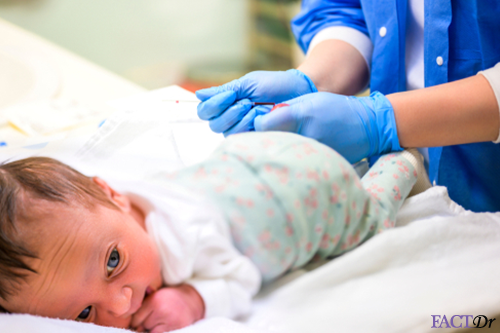 Baby undergoing newborn screening tests